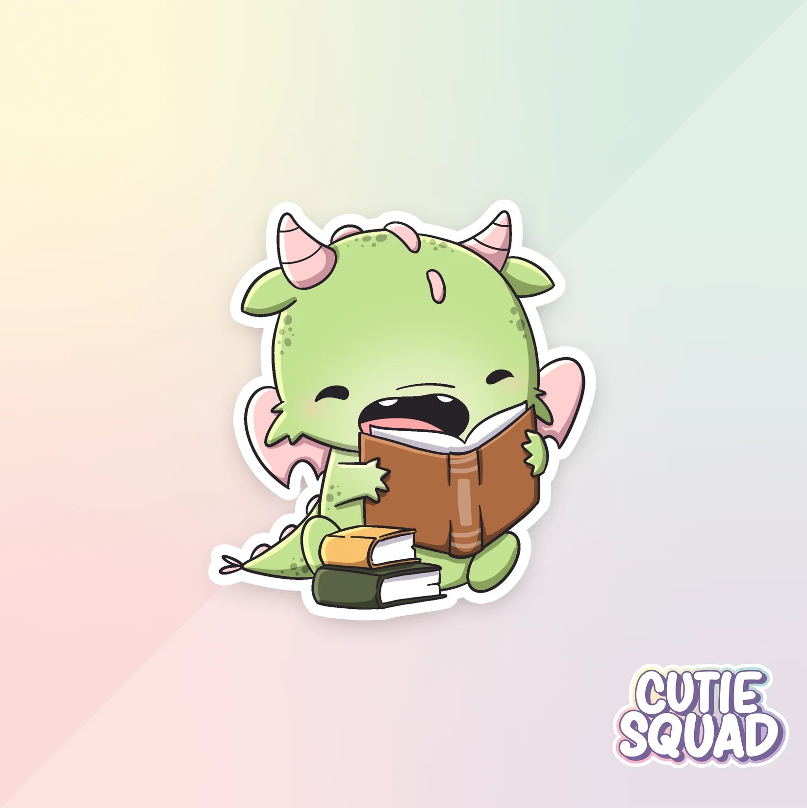 bookdragons sticker van cutiesquad met stapeltje boeken en lezend
